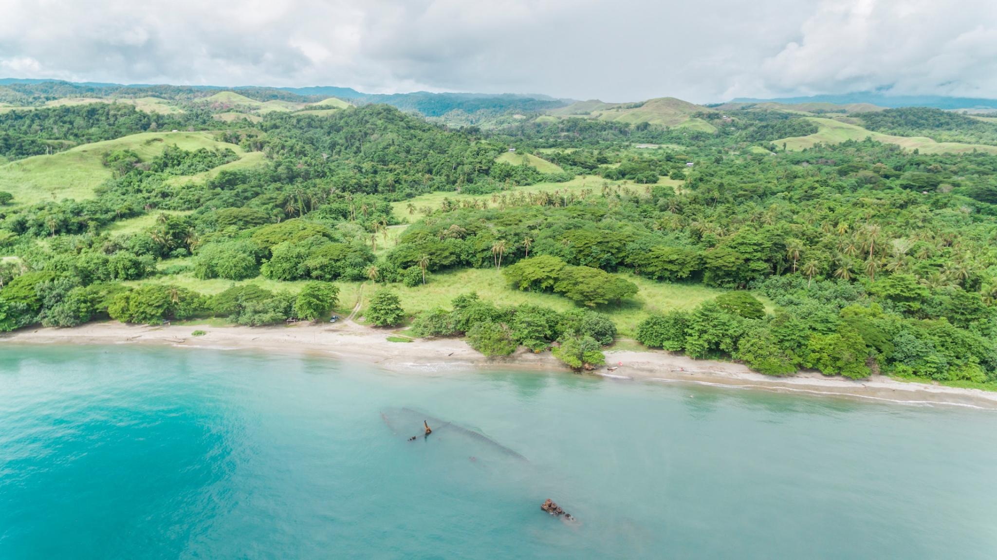 Aerial view of the World War II shipwreck of a Japanese transport ship (Kinugawa Maru) that lies just off a beach on Guadalcanal, one of the Solomon islands