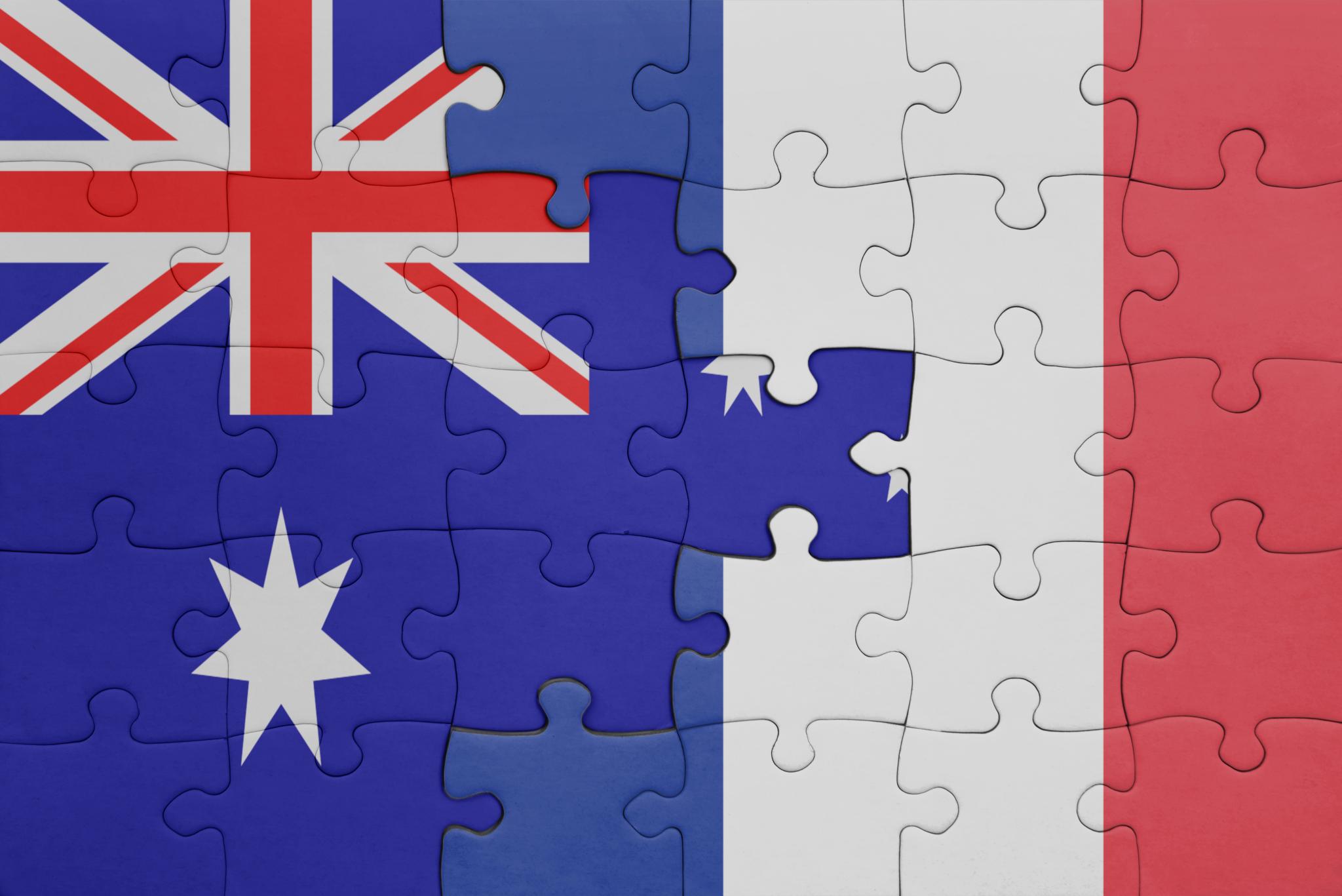 The flag of France and the flag of Australia superimposed onto puzzle pieces