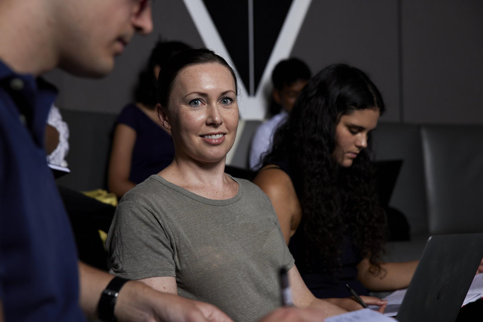 Woman in classroom working on computer