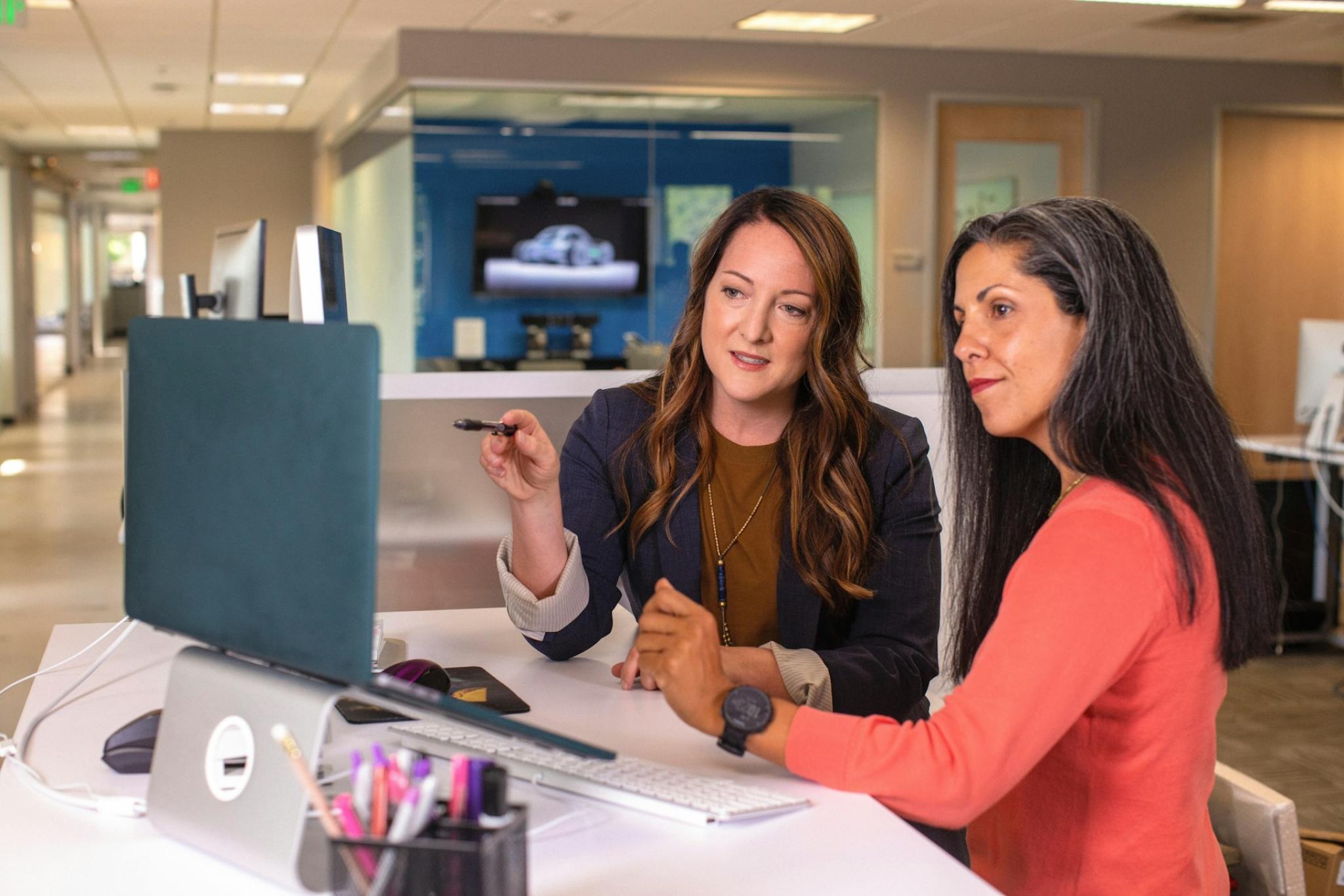 Two women in an office, in a discussion.