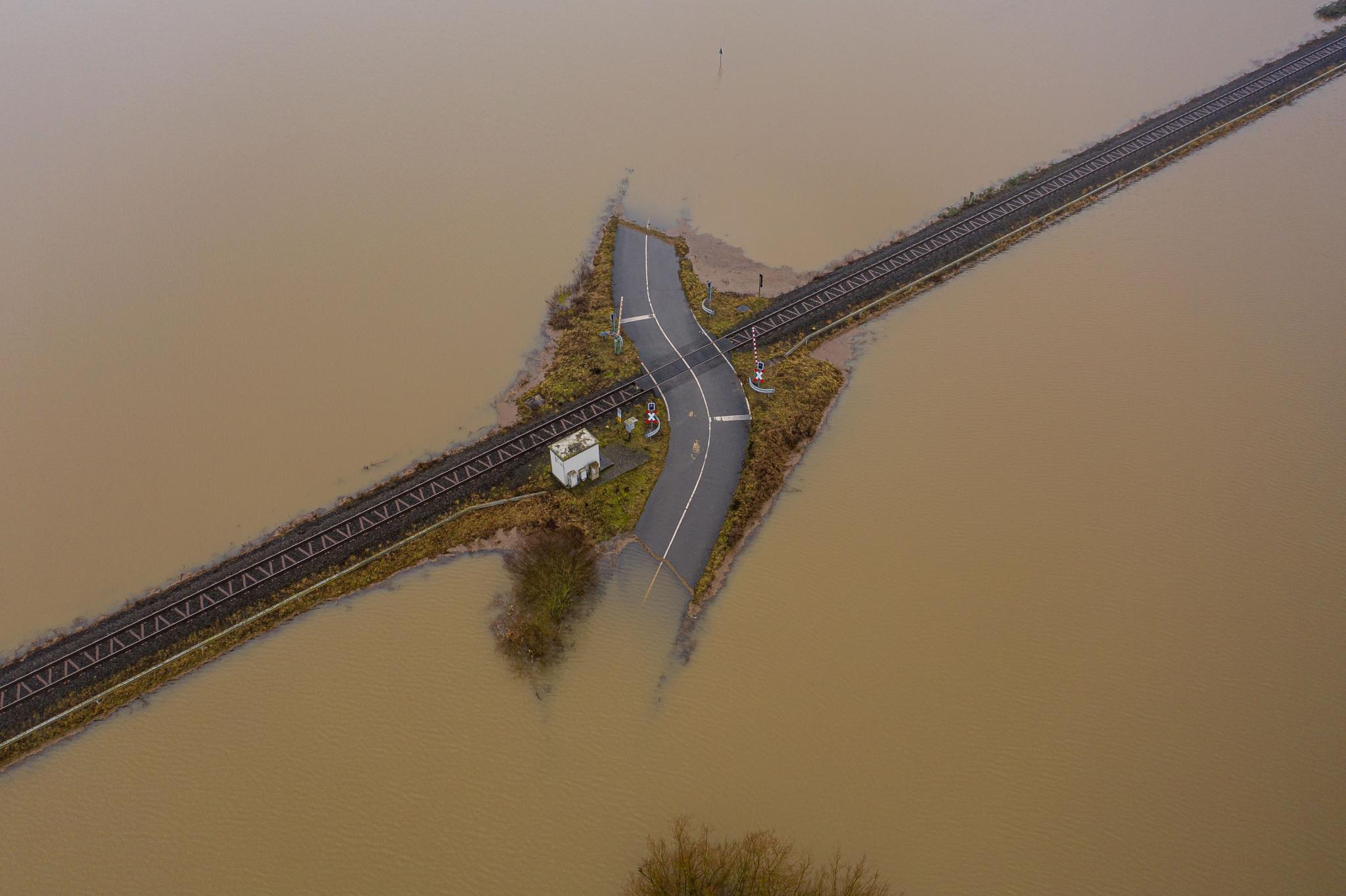 Flooded road passing through the railway. A road under water