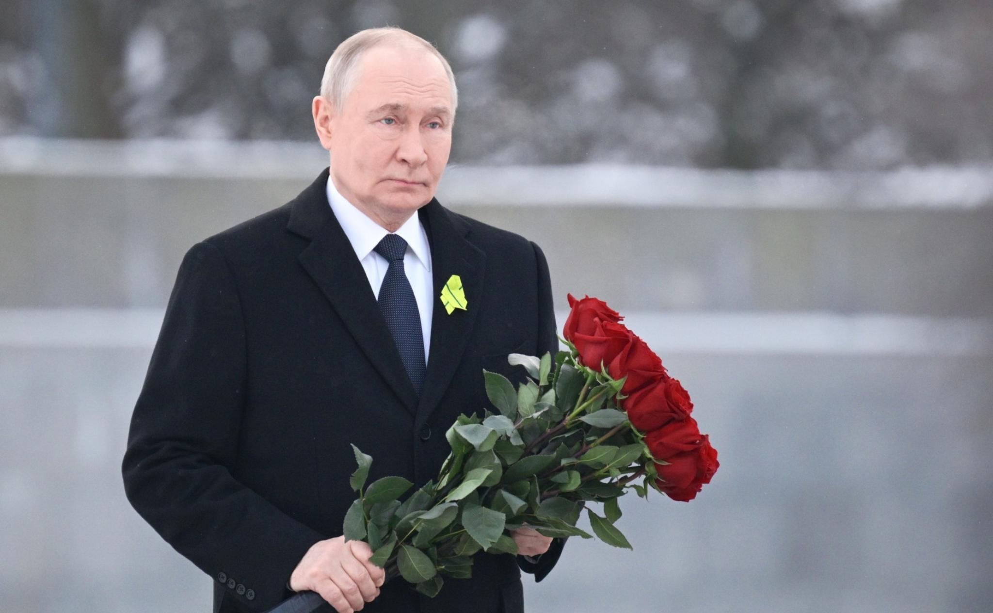 Putin laying flowers at the Motherland monument at Piskaryovskoye Memorial Cemetery