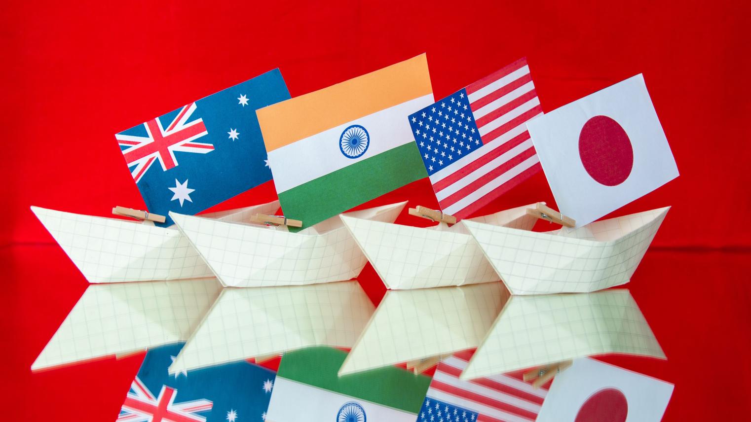 Australian, Indian, US and Japanese flags on paper boats