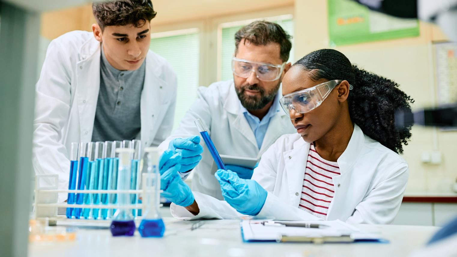 3 scientists looking at test tubes