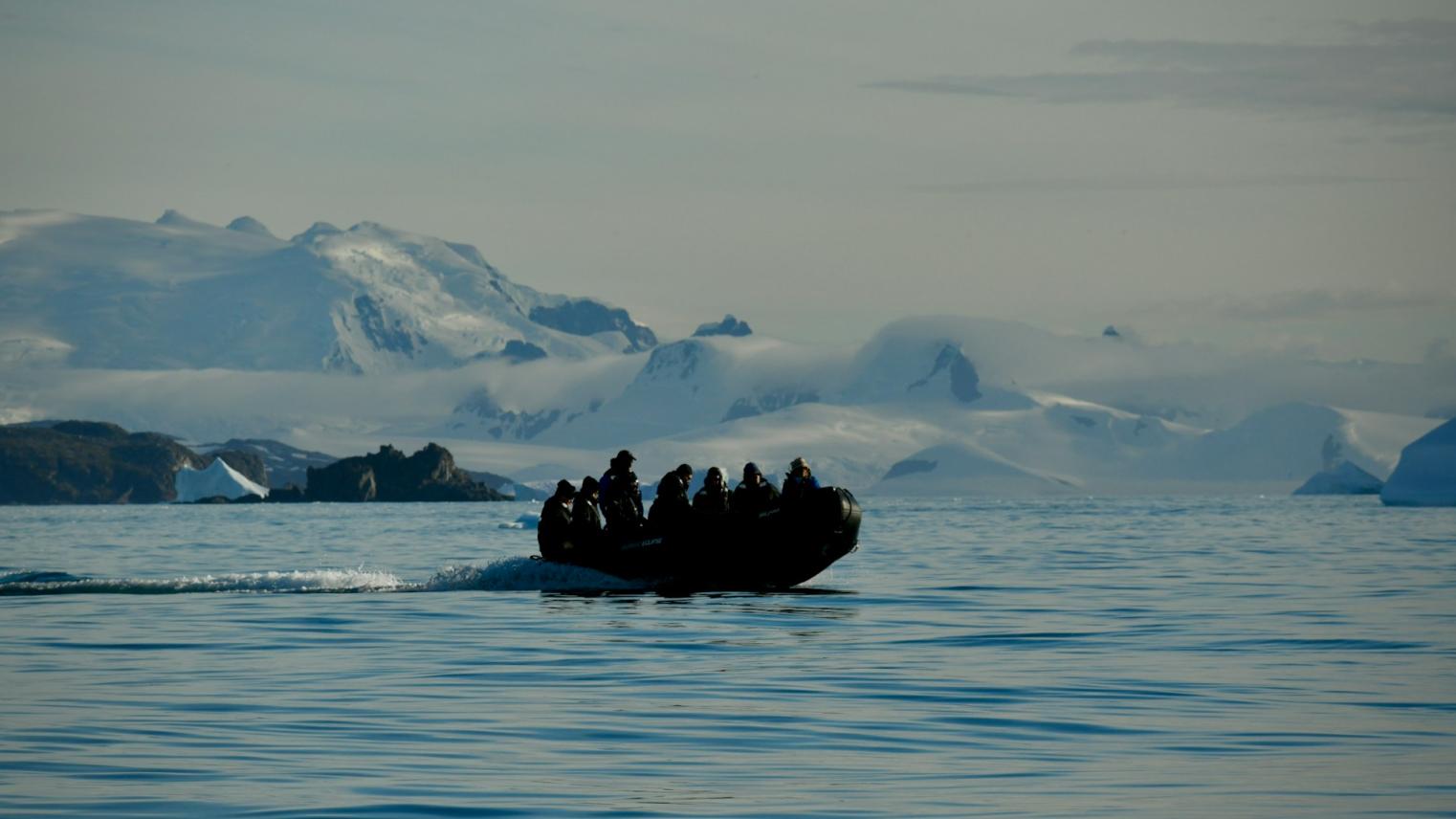 Boat in Antarctica with icebergs in the background