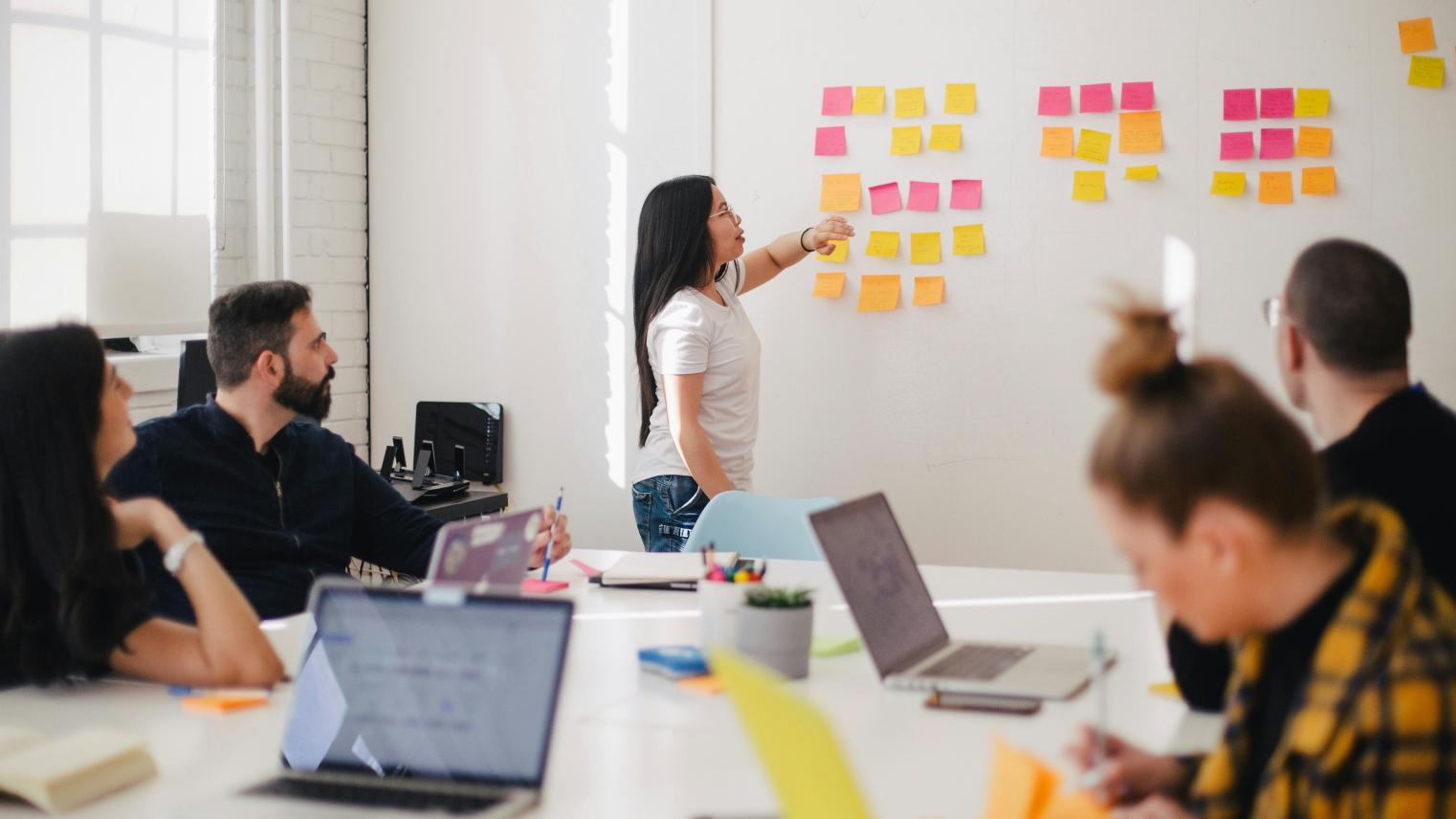 Woman placing sticky notes on wall