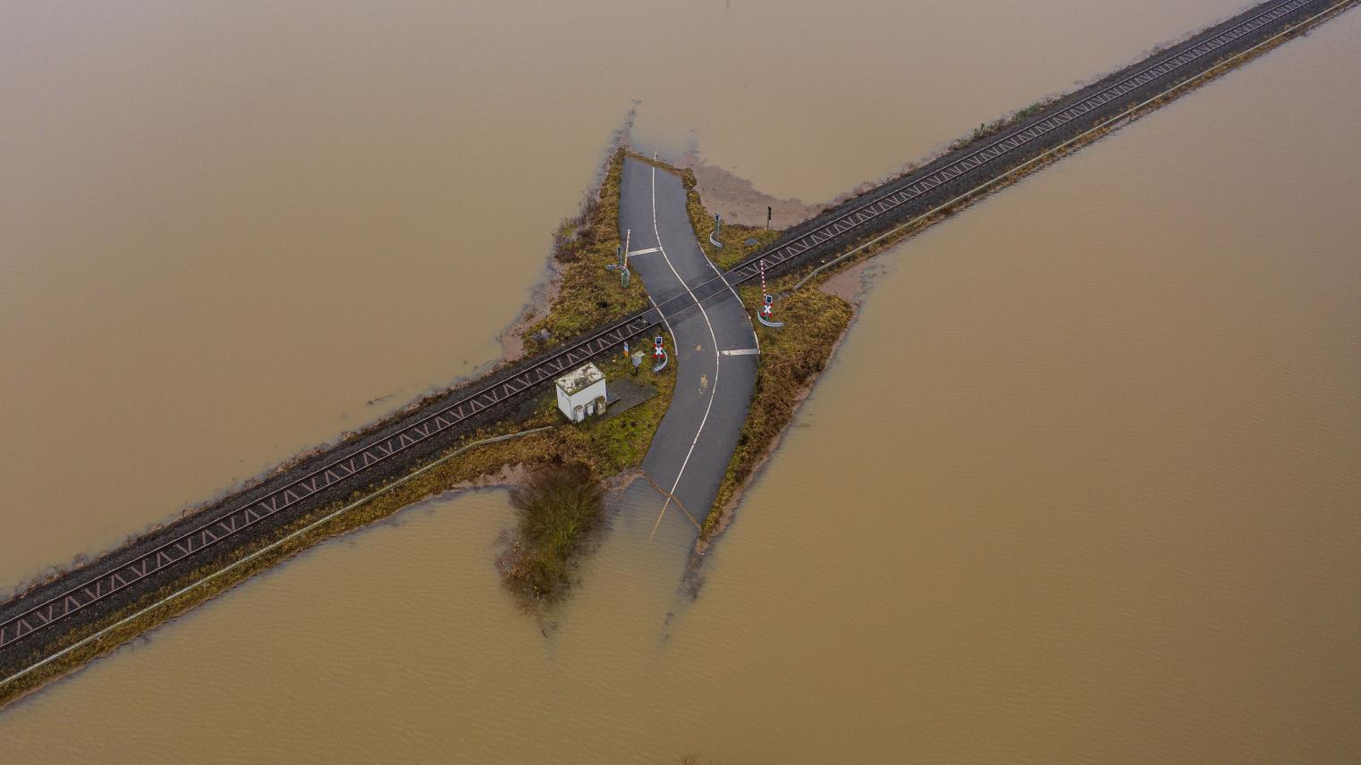 Flooded road passing through the railway. A road under water